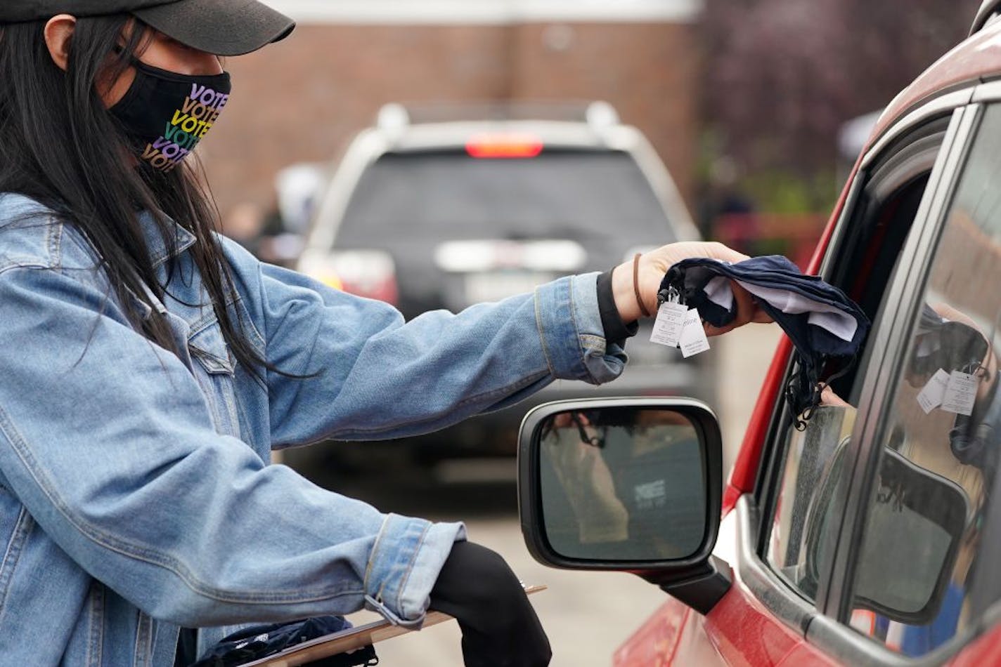 Amelia Barr handed out masks during a "Fuel the Vote" event Saturday.