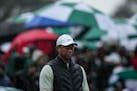 Tiger Woods walked the 18th hole as rain fell at Augusta National during the second round of the Masters on Saturday.