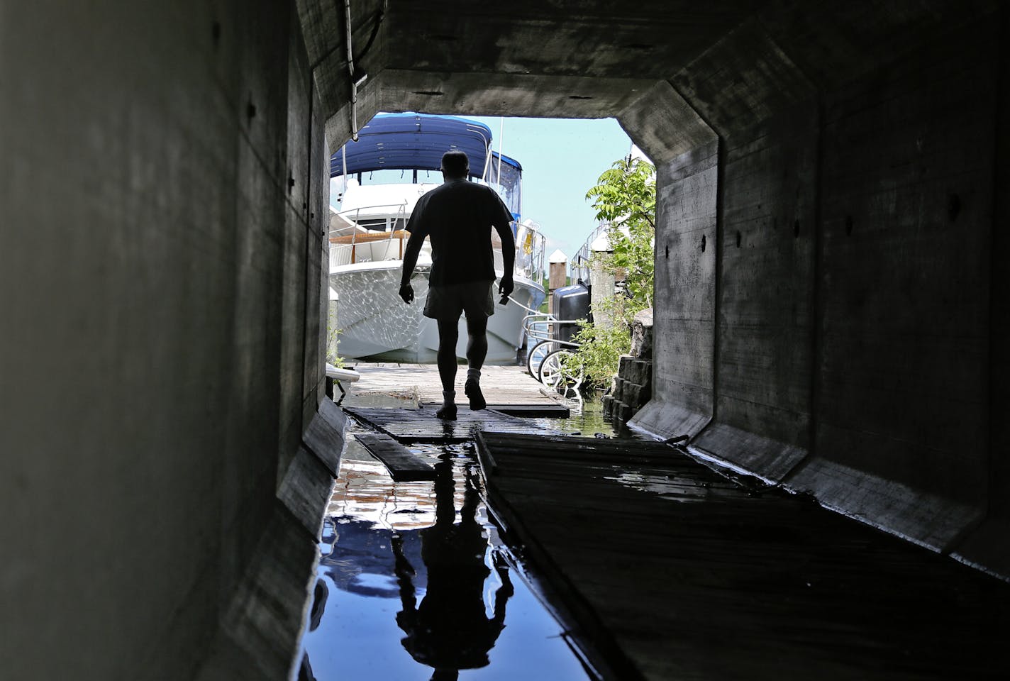 A rash of frequent, heavy rains has left Lake Minnetonka spilling over at a record height. A rash of frequent, heavy rains has left Lake Minnetonka spilling over at a record height. At the Tonka Bay Marina in Excelsior Bay, Marina owner Gabriel Jabbour, a former Orono mayor, walks to a partially flooded walkway to get to the boats and yachts anchored there Wednesday, June 4, 2014, in Tonka Bay MN. For safety reasons. Jabbour shut down the electricity to boats and yachts in another of his Lake Mi