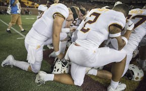 Minnesota players took a knee in prayer after the season opener against New Mexico State.