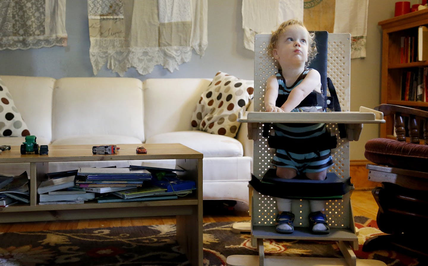 Wendell Sherman-Strand, 2, of Minneapolis was held up right and secured to a board with straps in the living room of his home as he worked with his personal care assistant. ] CARLOS GONZALEZ cgonzalez@startribune.com June 17, 2013, Minneapolis, Minn., 2-year-old Wendell Sherman-Strand has such a rare condition that his doctors have been unable to identify it. It's left him with little muscle tone, unable to stand or walk or talk. Now his doctors are taking the unusual step of having his entire g