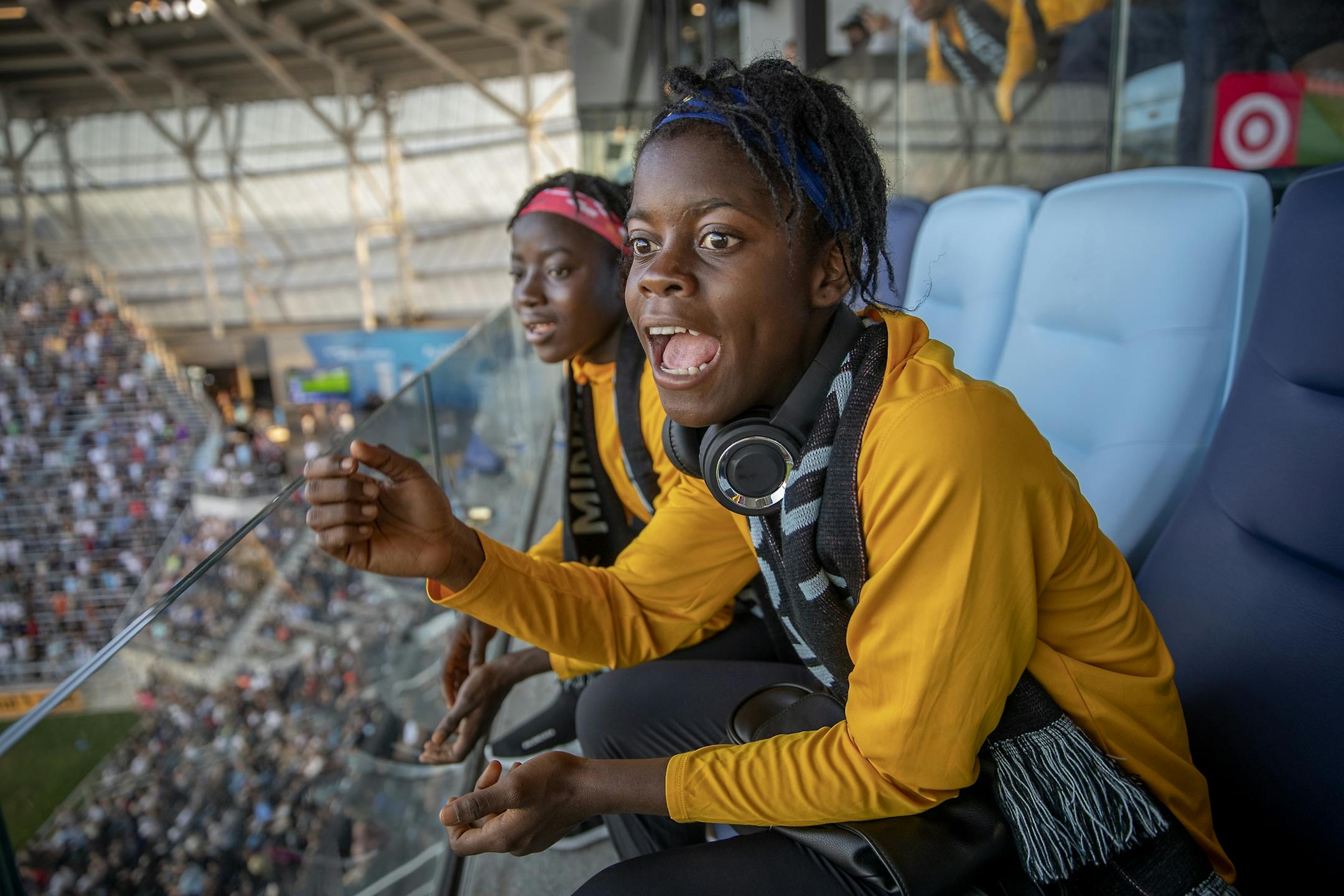 Monrovia Football Academy's Blessing Browne, right, and Blessing Kieh, left, cheered on the Minnesota United Loons during a friendly game from a suite the team gave them at Allianz Field, Wednesday, July 18, 2019 in St. Paul, MN.