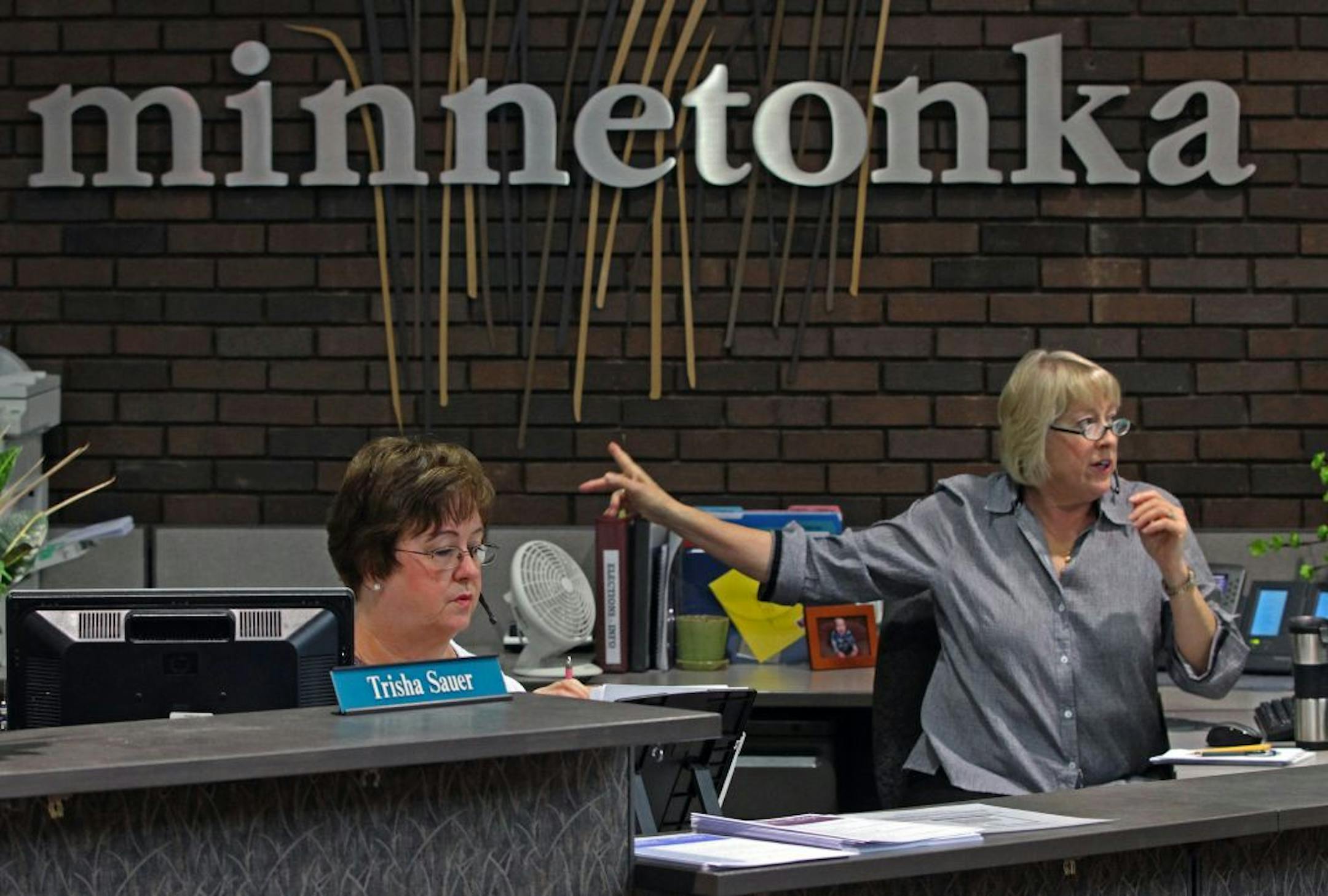 Minnetonka City Hall receptionists Trisha Sauer, left, and Bonnie Rislund, answered questions and gave directions to visitors.