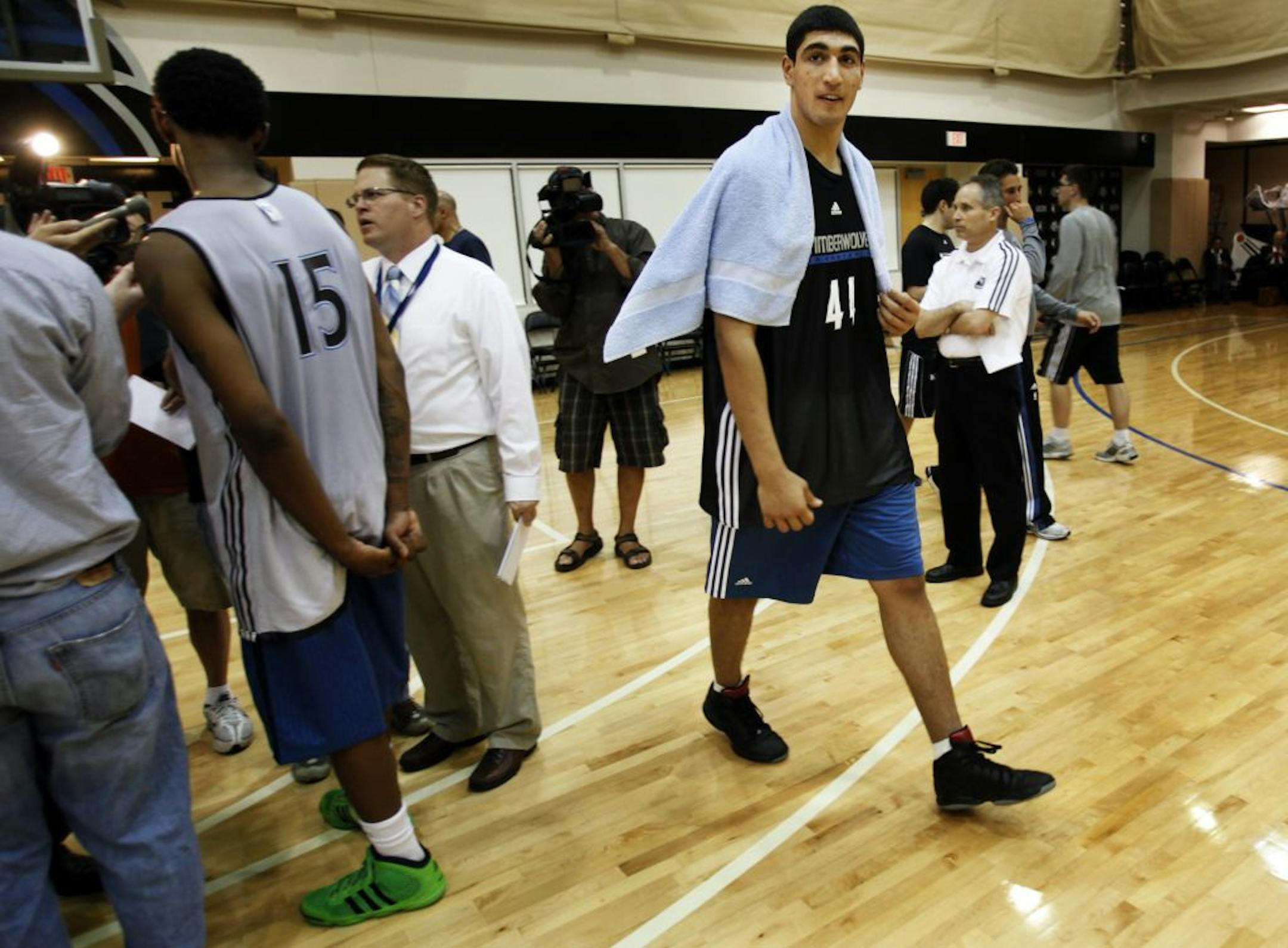 Turkish draft prospect Enes Kanter was among several draft prospects working out at Target Center Thursday. Here, following a media interview in the gymn following the workout, Kanter walks off as media members interview Marshon Brooks. ** (cq) Enes Kaanter (media release) and Marshon Brooks