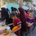 Palestinians receive food in Rafah in the southern part of the Gaza Strip on Nov. 8.