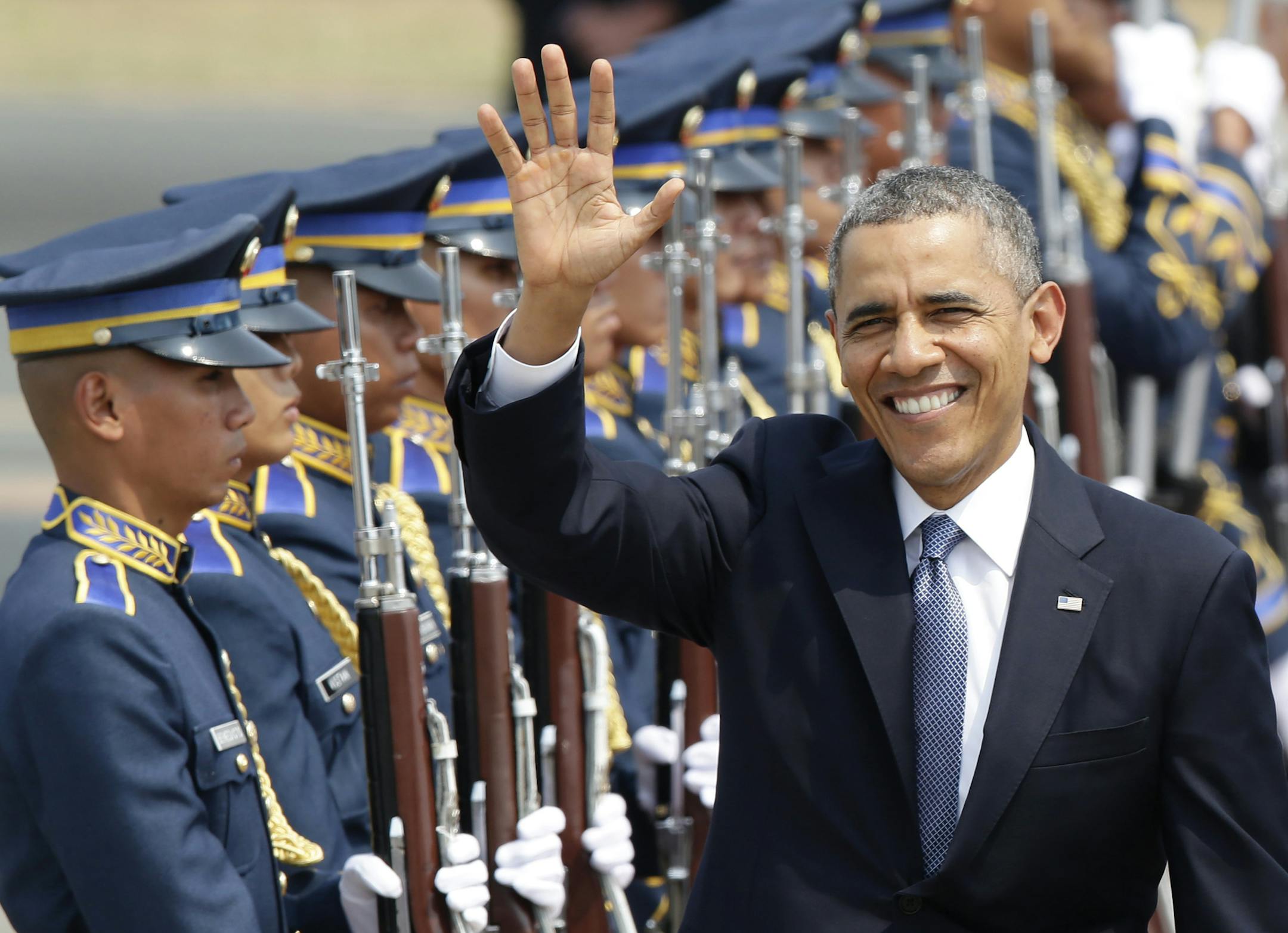U.S. President Barack Obama waves to the media upon arrival, Monday, April 28, 2014, at the Ninoy Aquino International Airport in Manila, Philippines. Trade and security are expected to be discussed in Obama's state visit to the Philippines. (AP Photo/Bullit Marquez)
