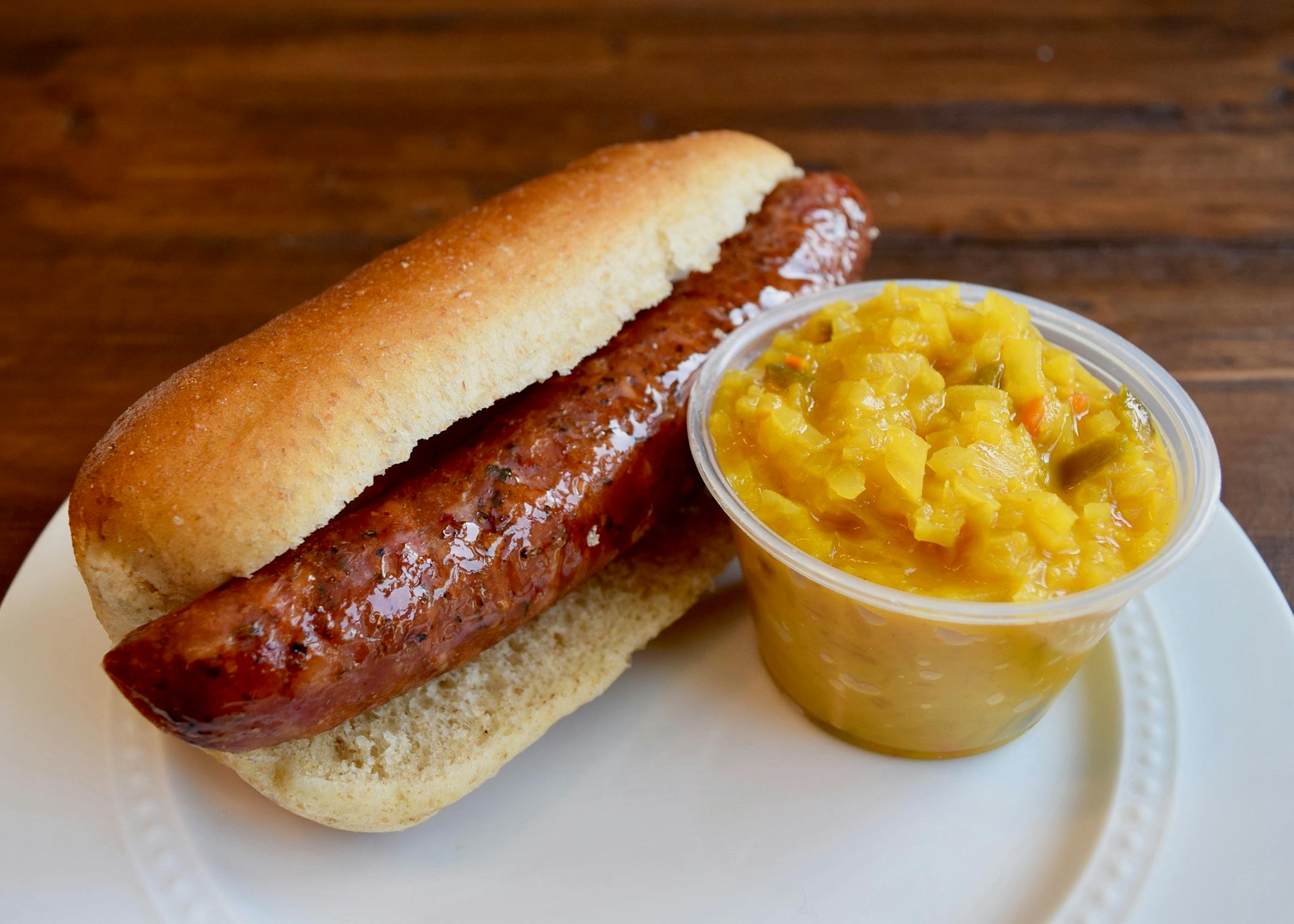 Turducken Sausage Sandwich: A blend of turkey, duck and chicken served on a fennel bun with a side of Giggles' sweet and saucy relish. Gluten-free; no nitrates added. At Giggles' Campfire Grill, located on the southeast corner of Lee Av. & Cooper St. at The North Woods