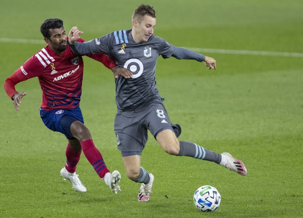 Thiago Santos (5) of Dallas FC and Jan Gregus (8) of Minnesota United FC fought for the ball in the first half. ] CARLOS GONZALEZ • cgonzalez@startr