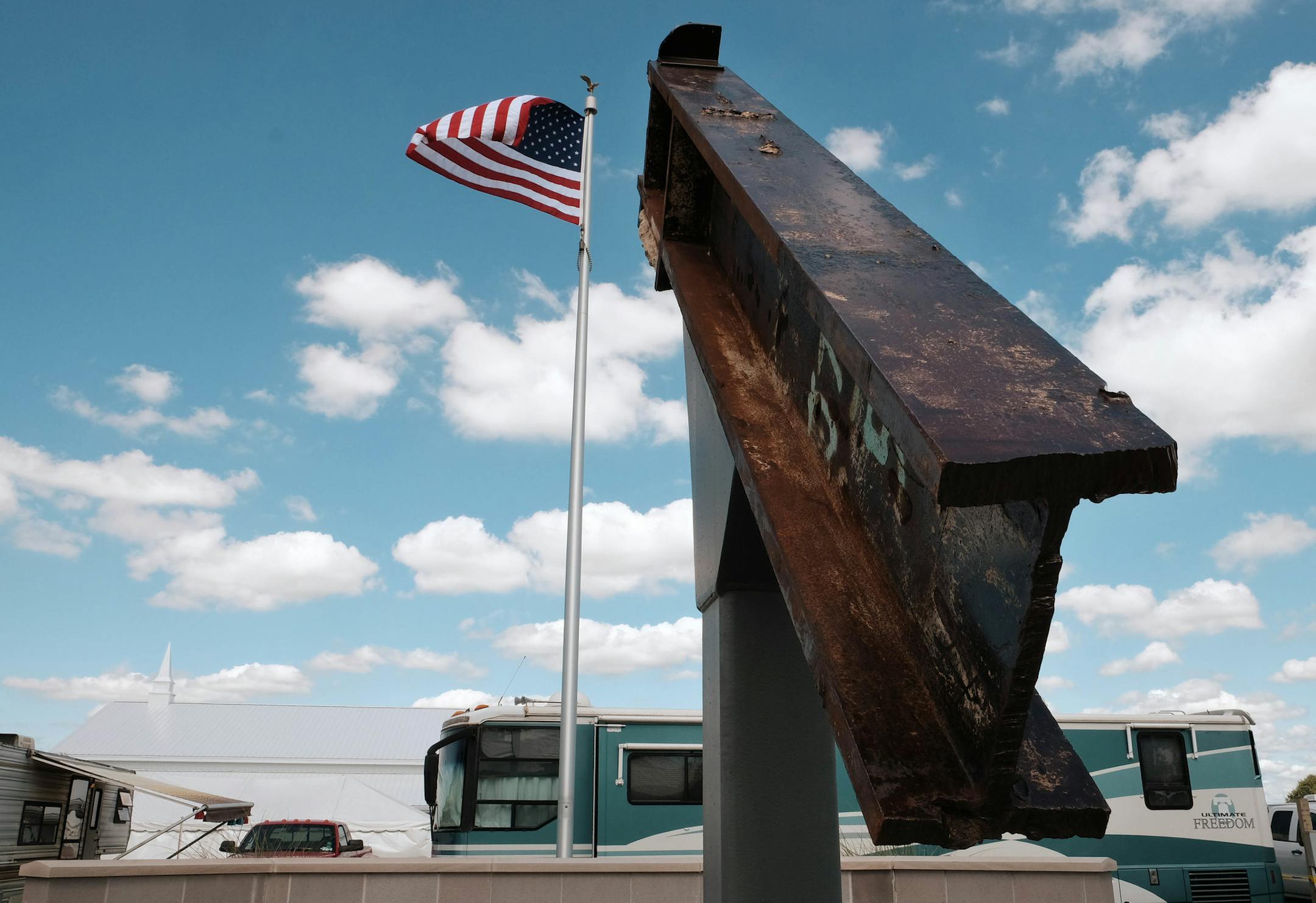 ADVANCE FOR USE SUNDAY, SEPT. 11, 2016 AND THEREAFTER-This Sept. 3, 2016 photo shows a beam from the destroyed World Trade Center buildings, part of the 9/11 Memorial near the Veterans' Pavilion at the Fulton County Fair, in Wauseon, Ohio. ìWe just donít know where the events of 9/11 have lead us,î said Rick Sluder, fire chief in Wauseon, Ohio, which obtained the beam and, together with neighboring departments built the memorial. "A lot of people are looking at this as, is this po