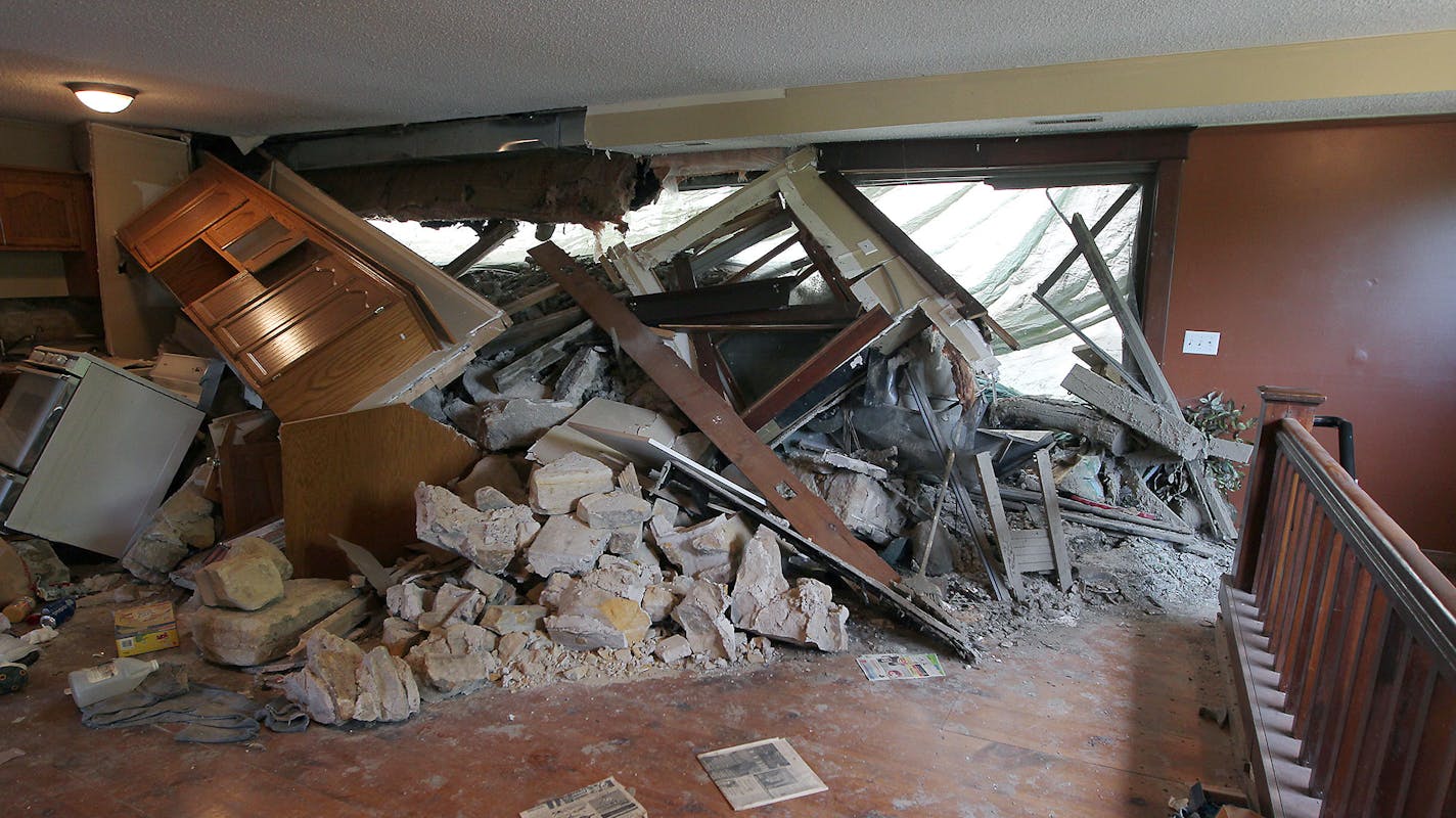 The remains of mudslide damage that forced a giant tree down a hill into the Jordan Brewery building, Friday, June 26, 2015 in Jordan, MN. ] (ELIZABETH FLORES/STAR TRIBUNE) ELIZABETH FLORES &#x2022; eflores@startribune.com