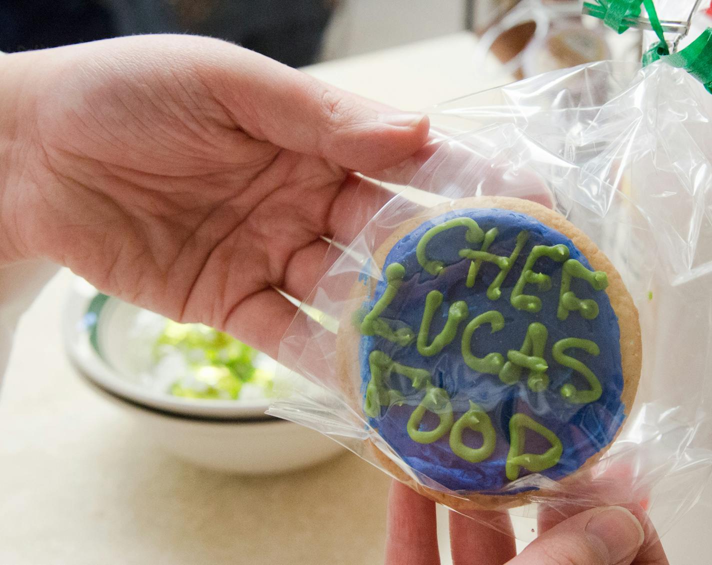 Lucas Hobbs, 13, displays a cookie that was dispersed to kids at the Dakota Woodlands, Wednesday morning. ] Elizabeth Brumley special to the Star Tribune Intern. * Chef Lucas Foods foudned by Lucas Hobbs, 13, began after his Make-A-Wish to give away free food to people with a foodtruck.