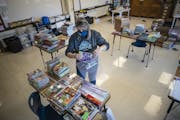 Teacher Gretchen Polkinghorne bagged donated books at Community of Peace Academy in St. Paul. Jerry Holt •Jerry.Holt@startribune.com