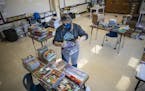 Teacher Gretchen Polkinghorne bagged donated books at Community of Peace Academy in St. Paul. Jerry Holt •Jerry.Holt@startribune.com