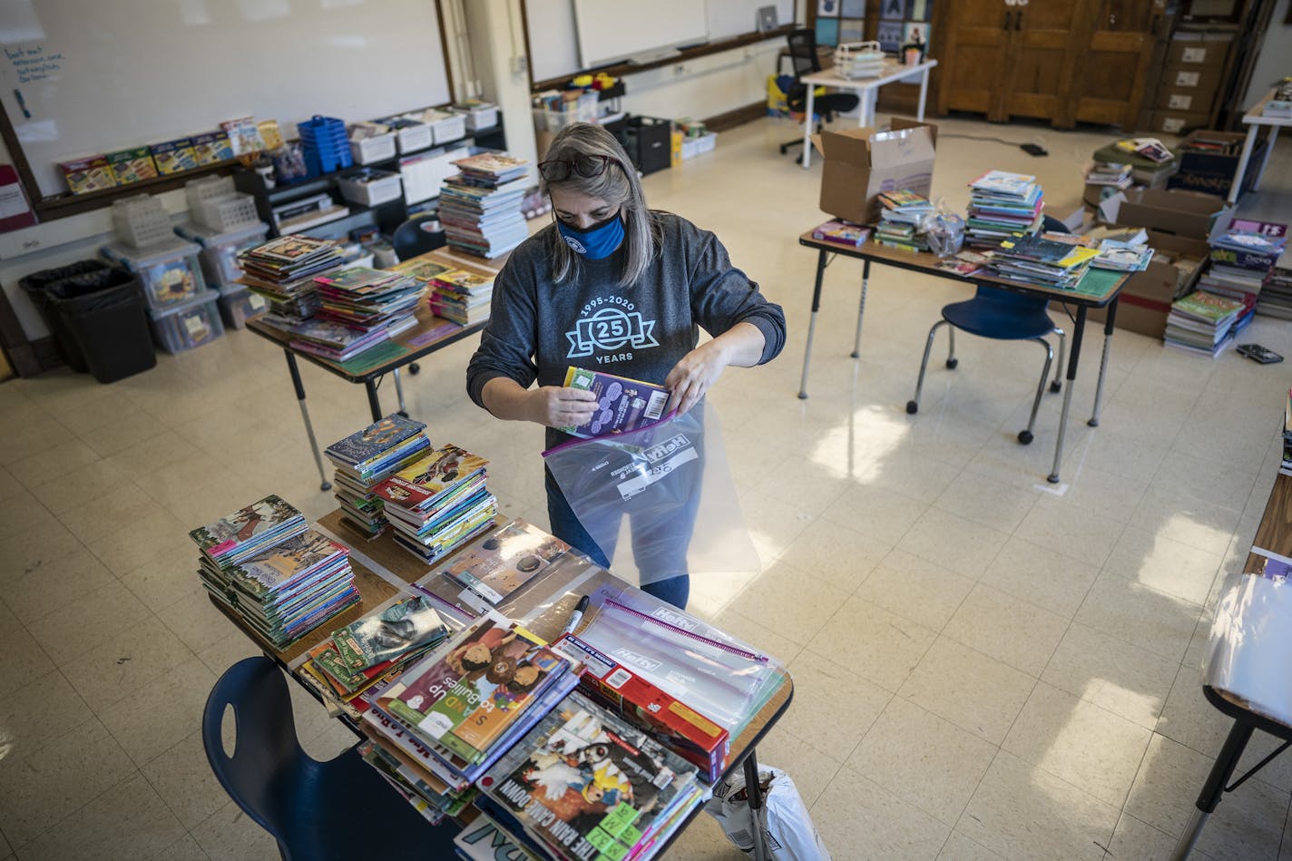 Teacher Gretchen Polkinghorne bagged donated books at Community of Peace Academy in St. Paul. Jerry Holt •Jerry.Holt@startribune.com