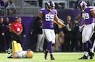 Minnesota Vikings outside linebacker Anthony Barr (55) celebrates with Danielle Hunter as Green Bay Packers quarterback Aaron Rodgers (12) lays on the