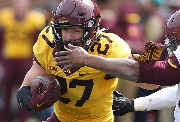 Minnesota running back James Johannesson (27) carries the ball during the team's spring scrimmage at TCF Bank Stadium in Minneapolis on Saturday, Apri