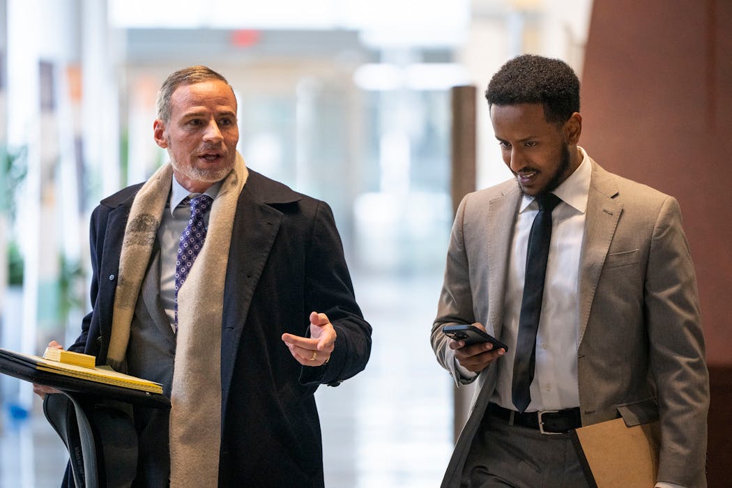 Defendant Abdimajid Mohamed Nur, right, walks into United States District Court with his attorney Edward Sapone on April 22 during the first day of jury selection in the first Feeding Our Future case to go to trial in Minneapolis. The eight defendants — Abdiaziz Shafii Farah, Mohamed Jama Ismail, Mahad Ibrahim, Abdimajid Mohamed Nur, Said Shafii Farah, Abdiwahab Maalim Aftin, Mukhtar Mohamed Shariff and Hayat Mohamed Nur — all have ties to Empire Cuisine & Market in Shakopee, which received more than $40 million in federal reimbursements for claiming to serve more than 18 million meals to children over 18 months.