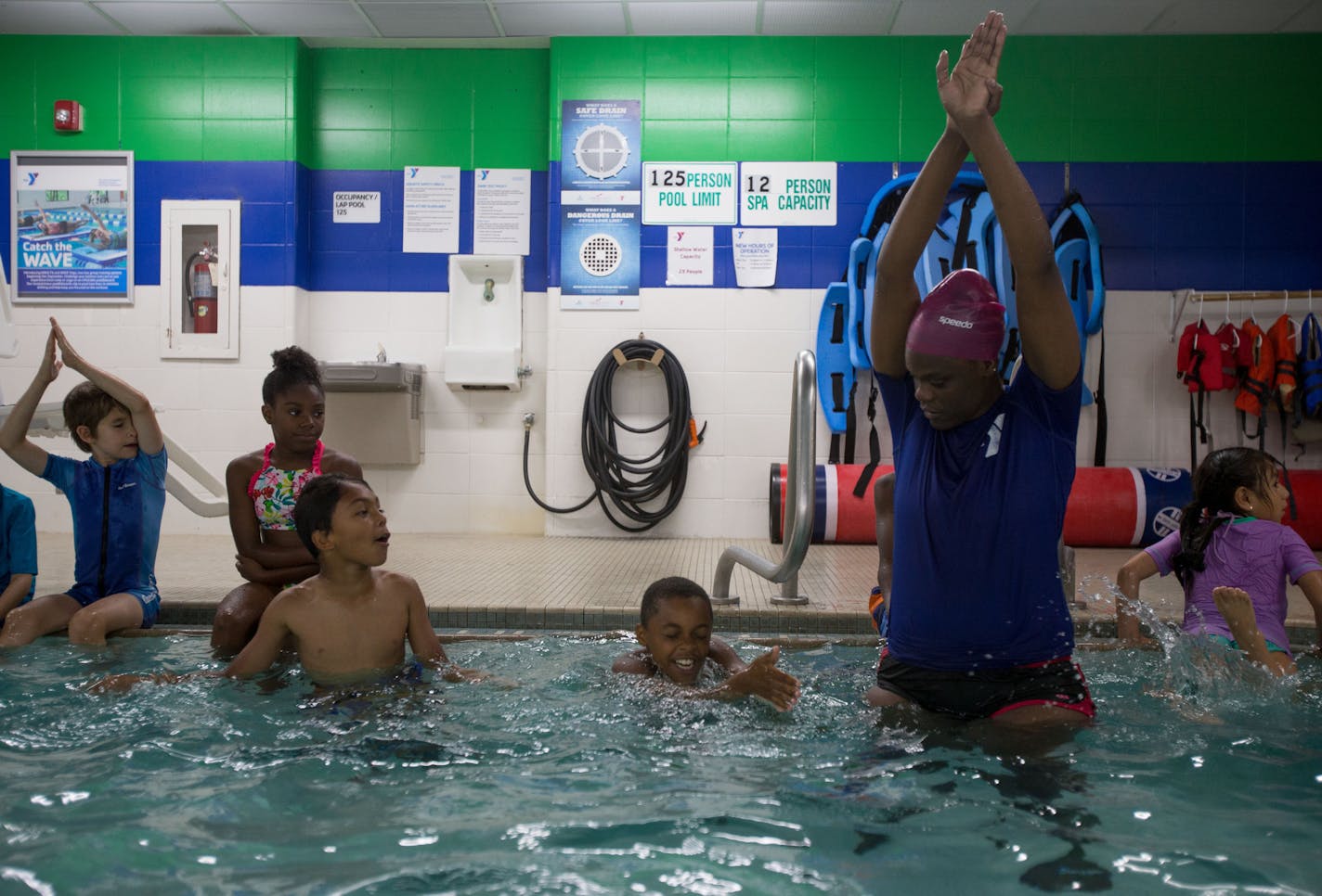 Danyelle Brooks demonstrates proper style and technique for launching off a wall. ] ALEX KORMANN • alex.kormann@startribune.com Statistics show that children of color are at a greater risk of drowning than white children. However, there are multiple programs throughout Minnesota helping to combat the dangers of swimming. One of these programs is at the Blaisdell YMCA in Minneapolis where they introduce water safety and survival techniques into basic swim lessons.