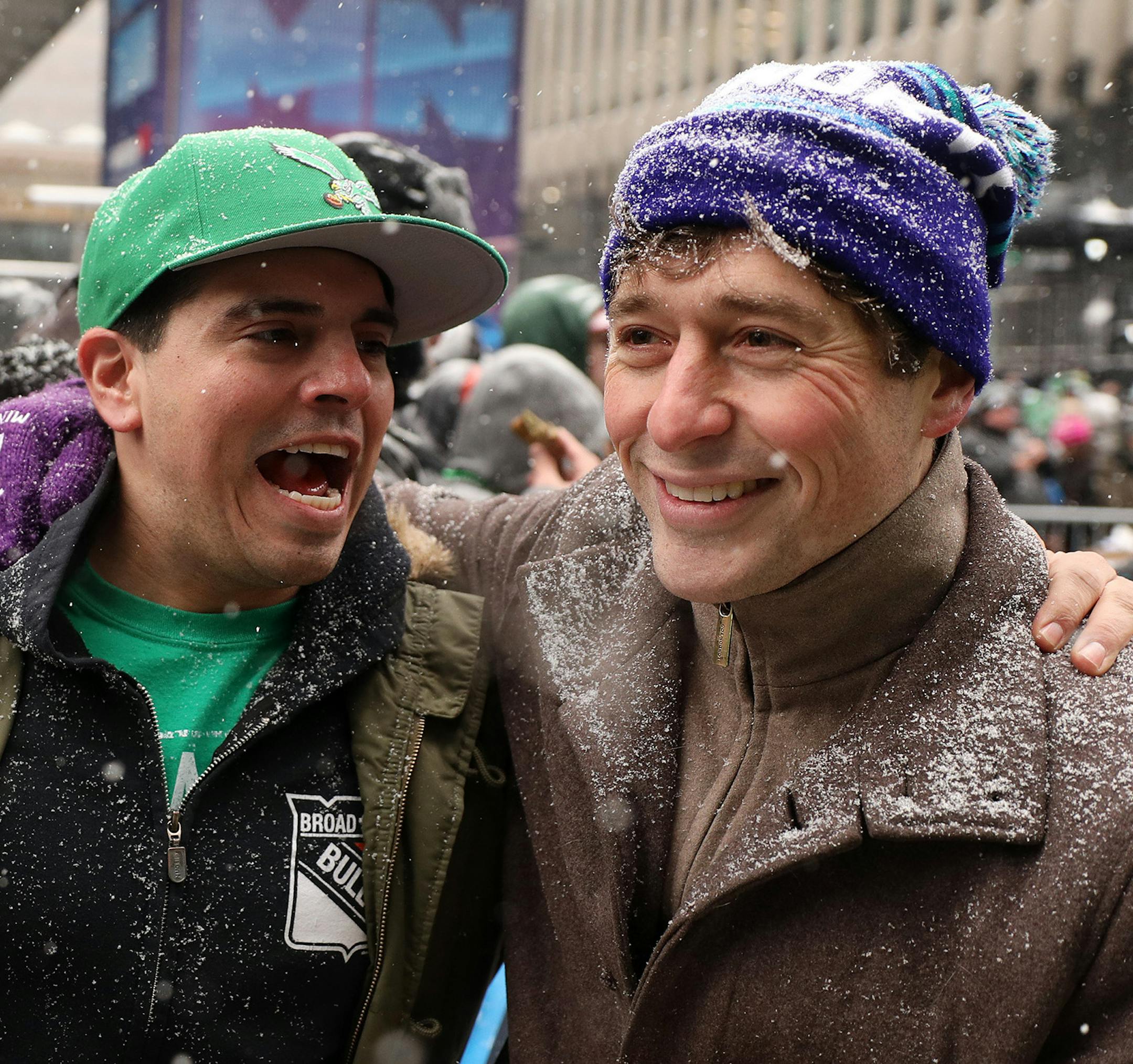 Minneapolis Mayor Jacob Frey bonded with Philadelphia Eagles fan Dave Shroyer as he handed out sambusas, a fried Somali dish with a savory filling from the restaurant Afro Deli, during their rally Saturday. ] ANTHONY SOUFFLE &#xef; anthony.souffle@startribune.com Super Bowl Live attendees took part in Saturday's festivities including an Eagles and Patriots rally as well as the Polaris UpsideDown stunt where Levi LaValle leapt a snowmobile over Nicollet Mall Saturday, Feb. 3, in downtown Minneapo