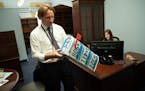 Congressman-elect Dean Phillips tried to figure out where some of his Minnesota memorabilia would go in his new congressional office in the Longworth 