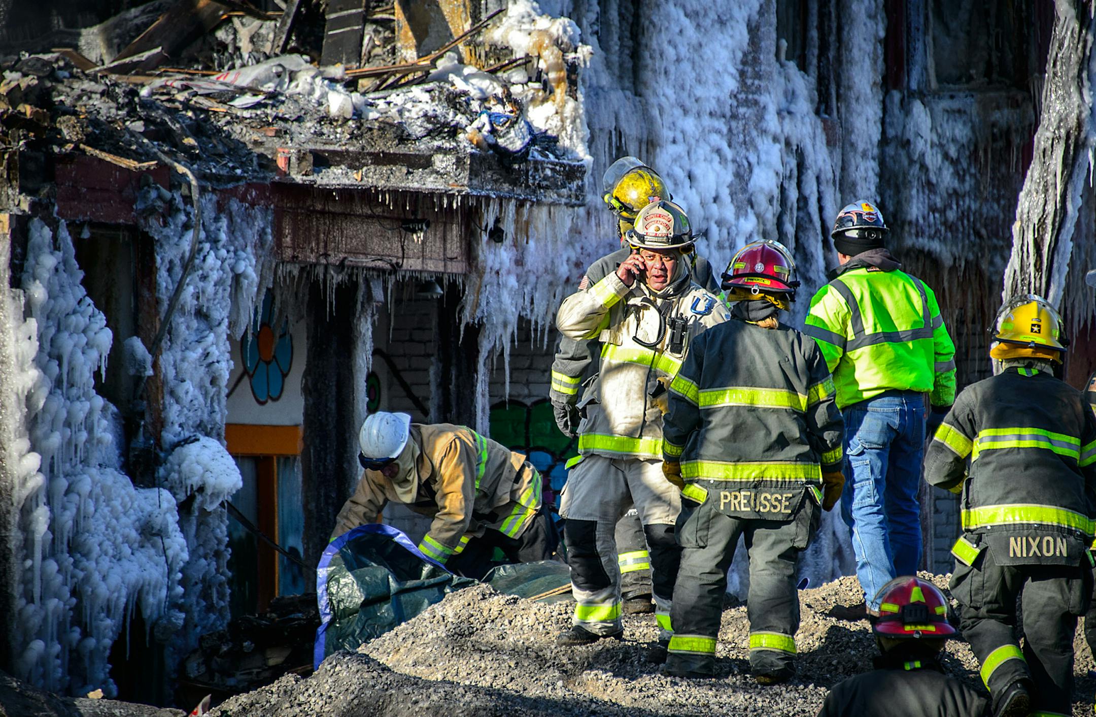 Backhoe work stopped when investigators found what is believed to be a victim. Investigators brought in a backhoe to knock down unstable walls in order to search for victims at the scene of Wednesday's fire on Cedar Ave near 6th Ave. Thursday, January 2, 2013 ] GLEN STUBBE * gstubbe@startribune.com ORG XMIT: MIN1401021559380665