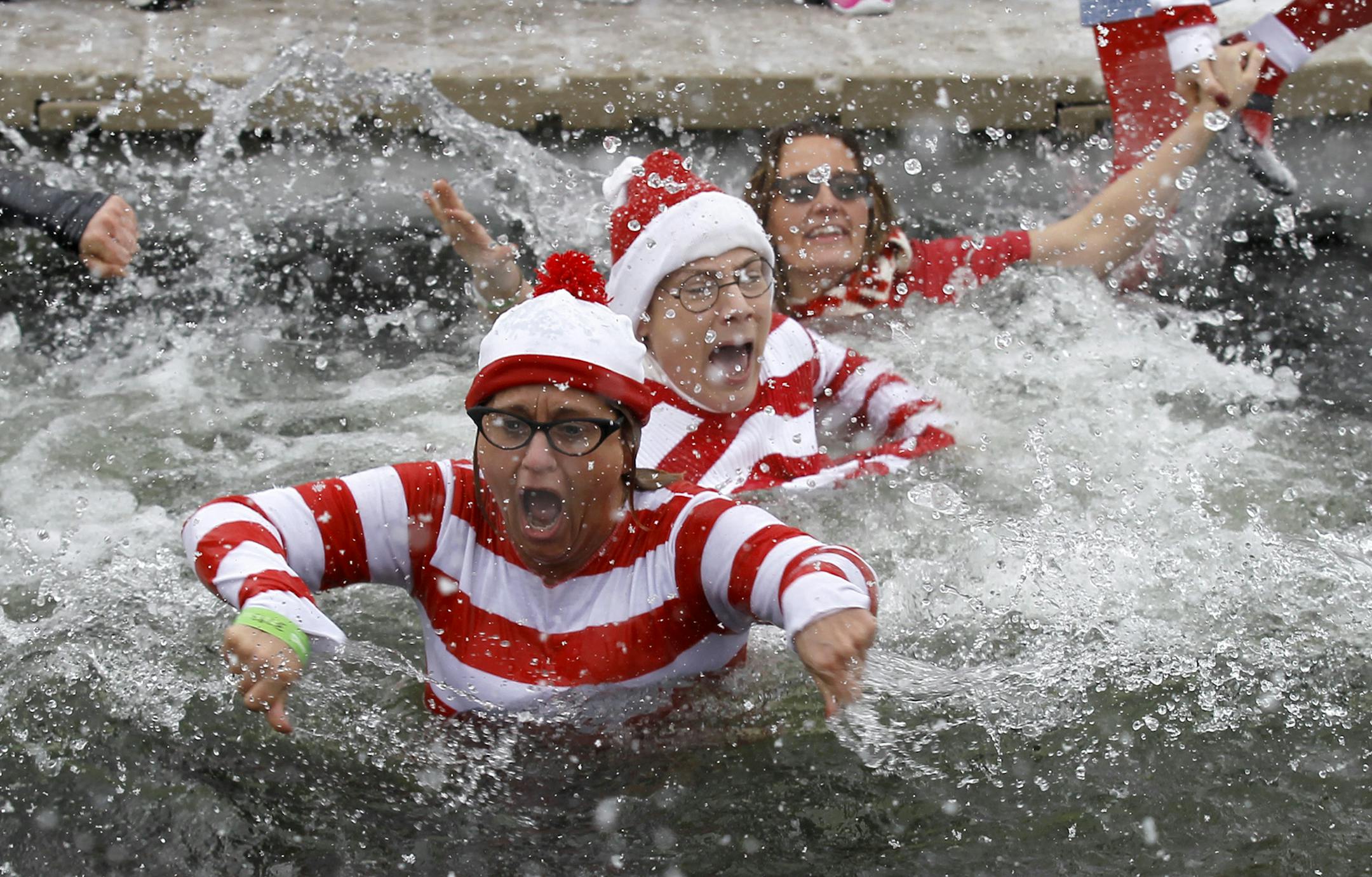 Plungers dressed as Waldo come up after jumping into the ice cold water at Sand Point Beach during a Polar Plunge for Special Olympics in Prior Lake, Saturday, Feb. 15, 2014. Over 800 people took part in the fund raising event. (Photo/Ann Heisenfelt) ORG XMIT: plunge0216141 ORG XMIT: MIN1402151539370398