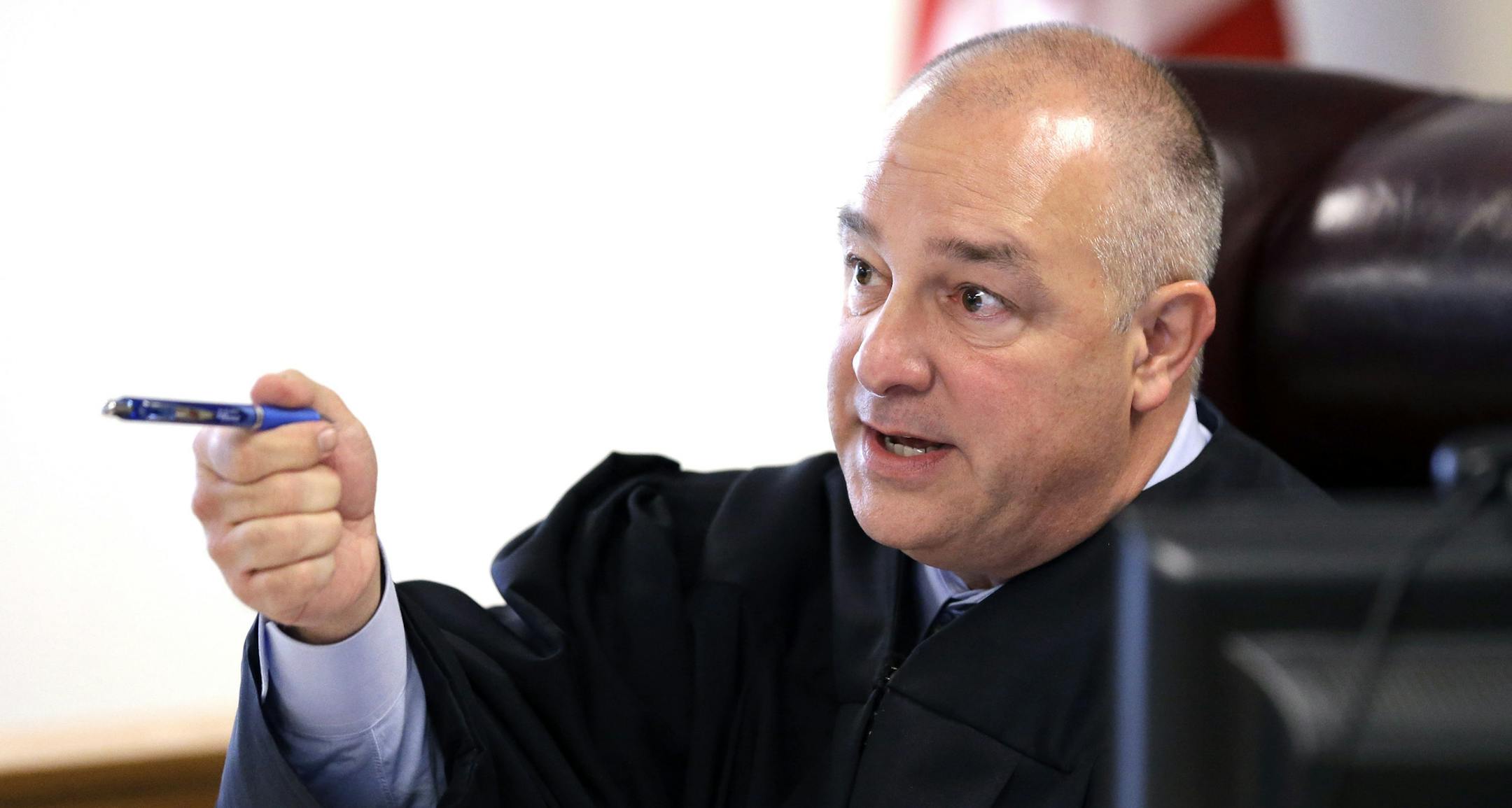State District Judge Kelly W. Case addresses the courtroom before calling the docket Wednesday, Oct. 8, 2014, in Conroe, Texas. Minnesota Vikings running back Adrian Peterson made his first court appearance in Case's court. The judge tentatively set a Dec. 1 trial date for Peterson on a charge of felony child abuse for using a wooden switch to discipline his 4-year-old son. (AP Photo/David J. Phillip, Pool)