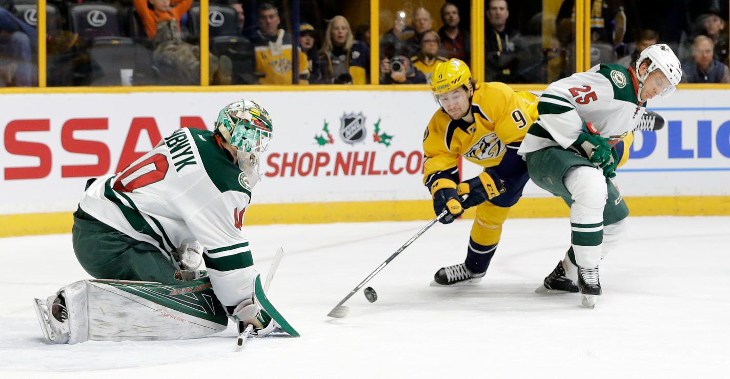 Nashville Predators left wing Filip Forsberg (9), of Sweden, is blocked by Minnesota Wild defenseman Jonas Brodin (25), of Sweden, as Forsberg shoots against Wild goalie Devan Dubnyk (40) during the second period of an NHL hockey game Thursday, Dec. 15, 2016, in Nashville, Tenn. (AP Photo/Mark Humphrey)