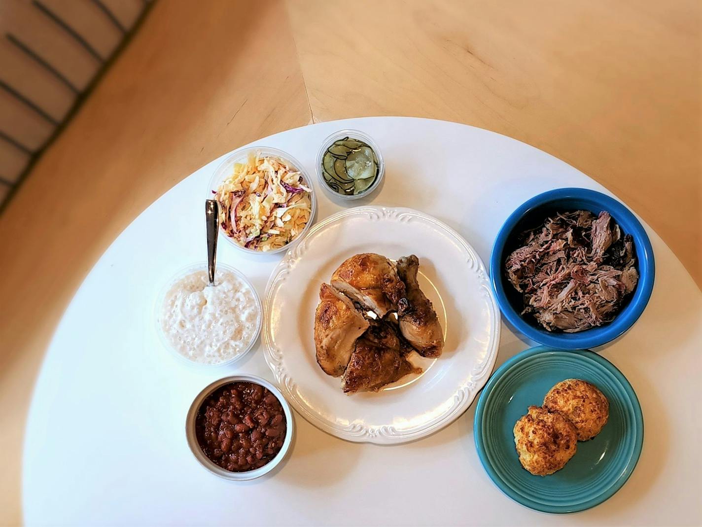 A table with a number of plates each with different foods from Brasa