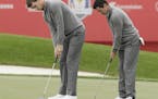 Europe's Rory McIlroy and Thomas Pieters putt on the 18th hole during a practice round for the Ryder Cup golf tournament Wednesday at Hazeltine Nation