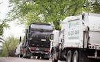 Waste disposal trucks line up on trash pickup day in Bloomington between France Avenue and Normandale Boulevard on Thursday, May 7, 2015.