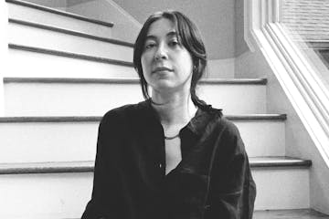 photo of author Alexandra Tanner, seated on a spiral staircase