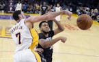 Los Angeles Lakers forward Larry Nance Jr., left, and Minnesota Timberwolves center Karl-Anthony Towns go after a rebound during the first half of an 