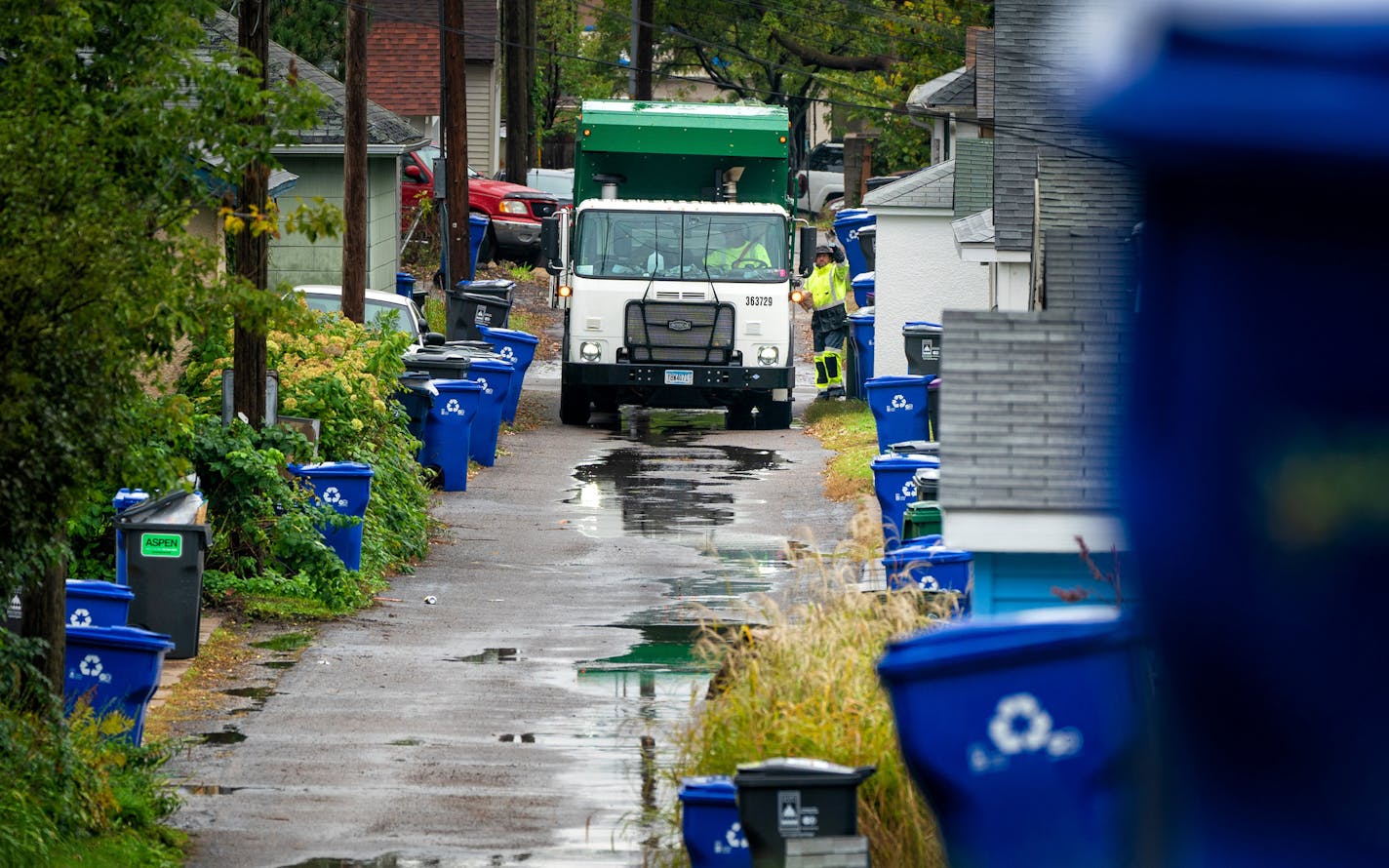 Waste Management worker Daniel Westerhaus collected trash from the alleys of the Snelling Hamline neighborhood of St Paul's yellow zone on the first day of organized trash collection. ] GLEN STUBBE &#x2022; glen.stubbe@startribune.com Monday, October 1, 2018 St. Paul has begun its organized trash collection, a dramatic shift in how the city collects its waste. Scattered reports of residents using the wrong bins, but so far no major snafus. What's Happening at this time: Organized trash collectio