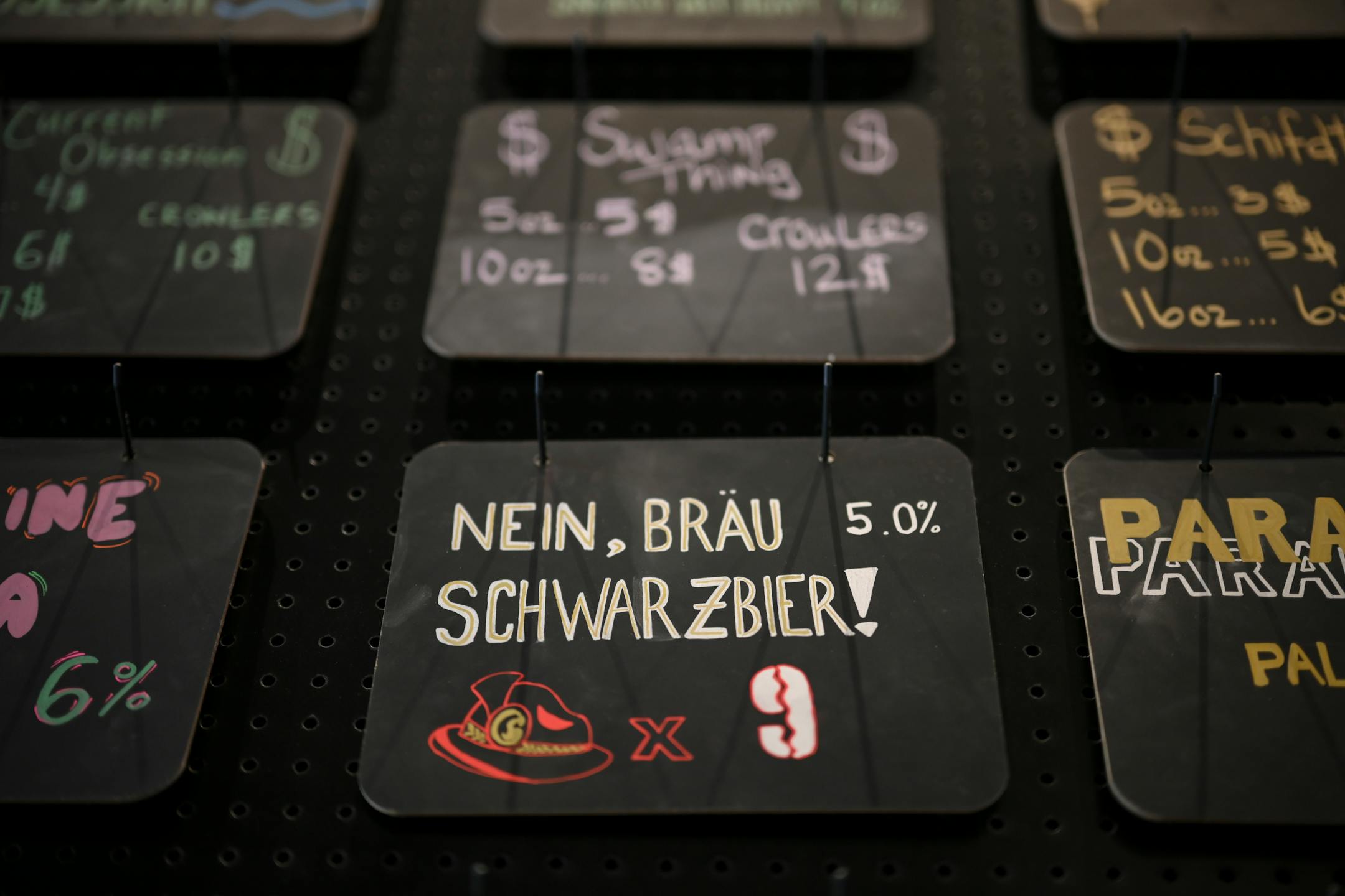 Nine Mile Brewing's beer offerings are posted behind the bar.
