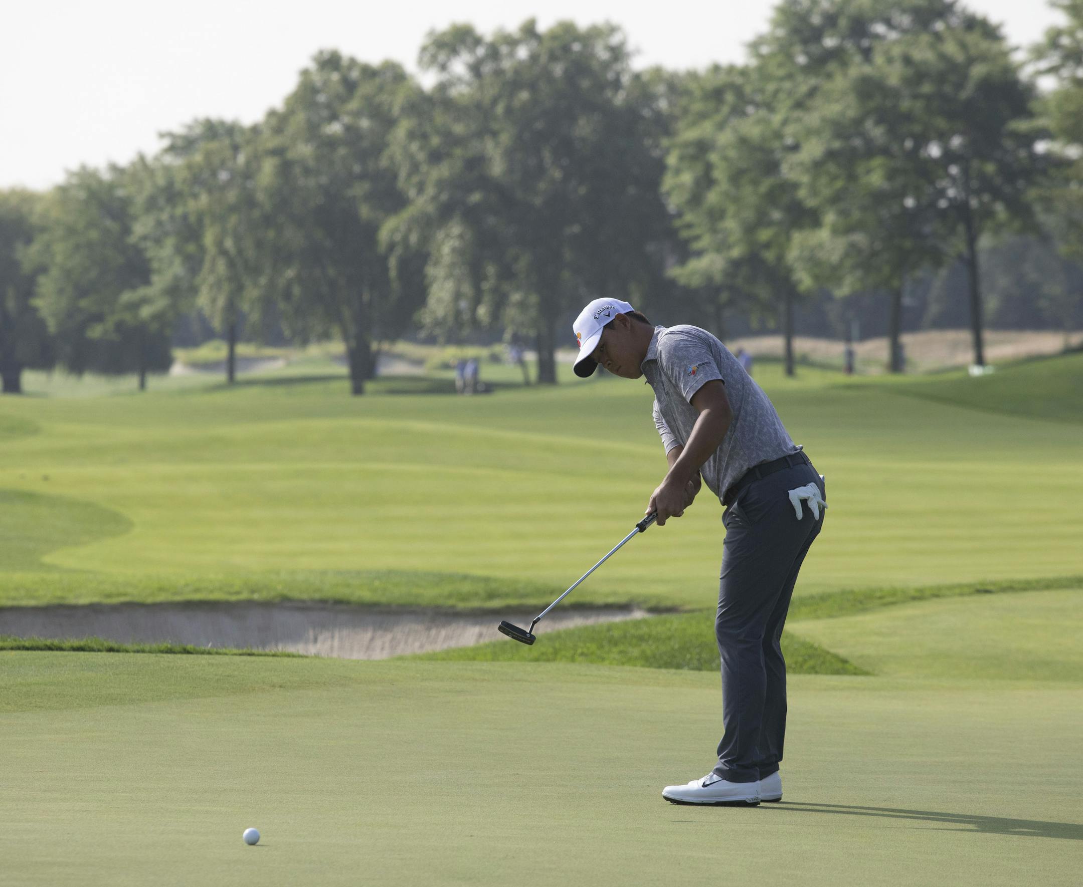 Si Woo Kim, of South Korea, putts on the seventh green in the Northern Trust tournament at Liberty National Golf Course, Thursday, Aug. 8, 2019, in Jersey City, N.J. (AP Photo/Mark Lennihan)