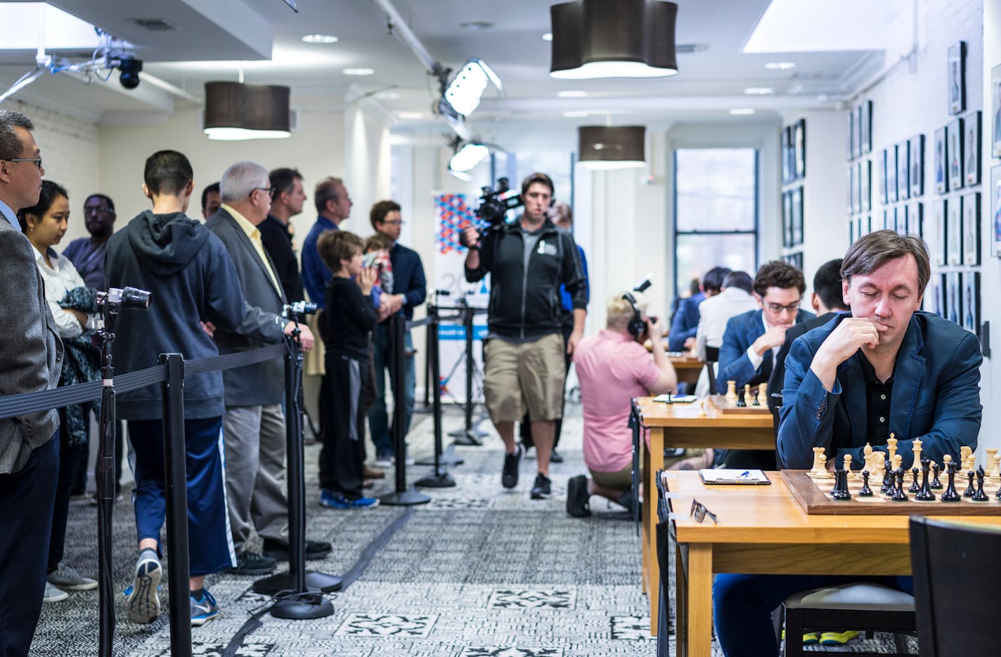 As spectators watch, cameras are trained on each board and photographers shoot video for the internet live-streaming broadcasts of world-class competitions at the Chess Club and Scholastic Center of St. Louis.