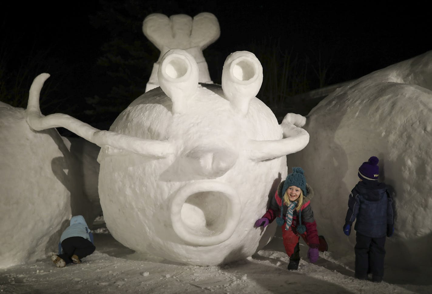 Grace Postma, 7, prepared to follow her brother, James, 4, left, through a tunnel under the the arm (claw?) of Diggs the Lobster shortly after it was unveiled Tuesday night. At right was Abram Vogel, 2. ] JEFF WHEELER &#xef; jeff.wheeler@startribune.com Connor, Trevor and Austin Bartz unveiled their annual front yard snow sculpture Tuesday night, January 16, 2017 in front of their family home on 16th St. NW in New Brighton. They're calling it Diggs the Lobster, after a certain Vikings wide recei