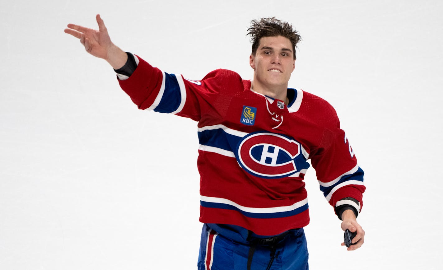 First star of the game, Montreal Canadiens' Juraj Slafkovsky, tosses pucks to the crowd after defeating the Arizona Coyotes in NHL hockey action in Montreal, Thursday, Oct. 20, 2022. (Paul Chiasson/The Canadian Press via AP)