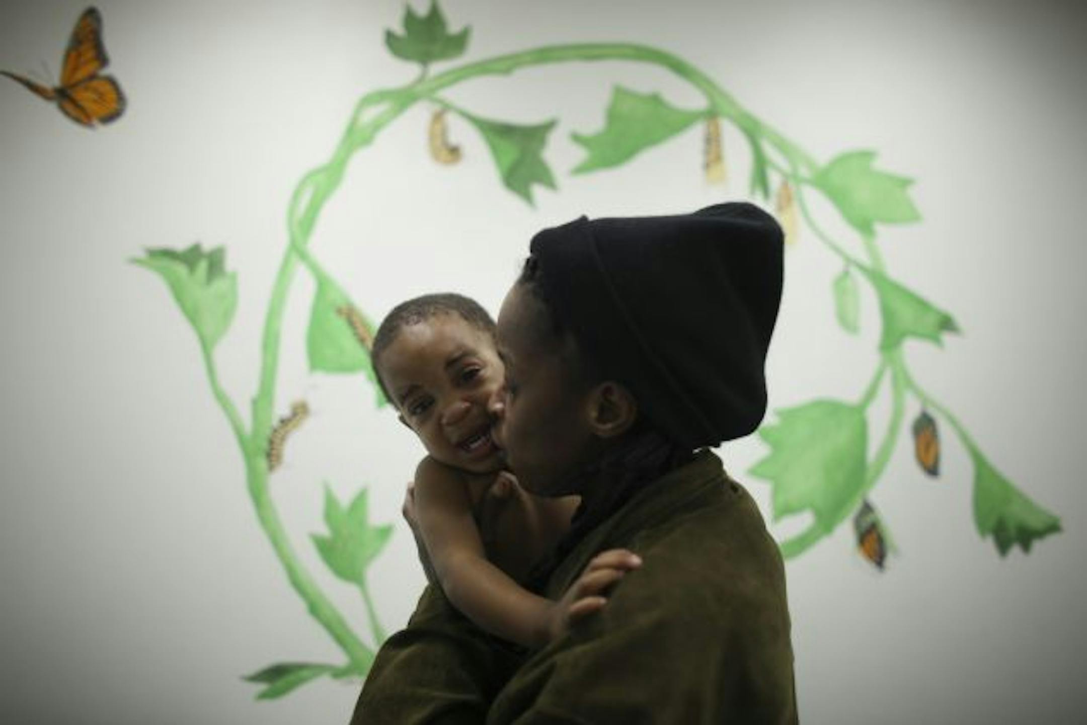 Angela Coleman comforted her son, Brandon Hill, after he got two shots during his 18-month checkup at HCMC.