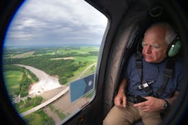 Gov. Tim Walz looks out at the overflowing Rapidan Dam in Southern Minnesota Tuesday, June 25, 2024  Mankato, Minn. Minnesota Governor Tim Walz tours 