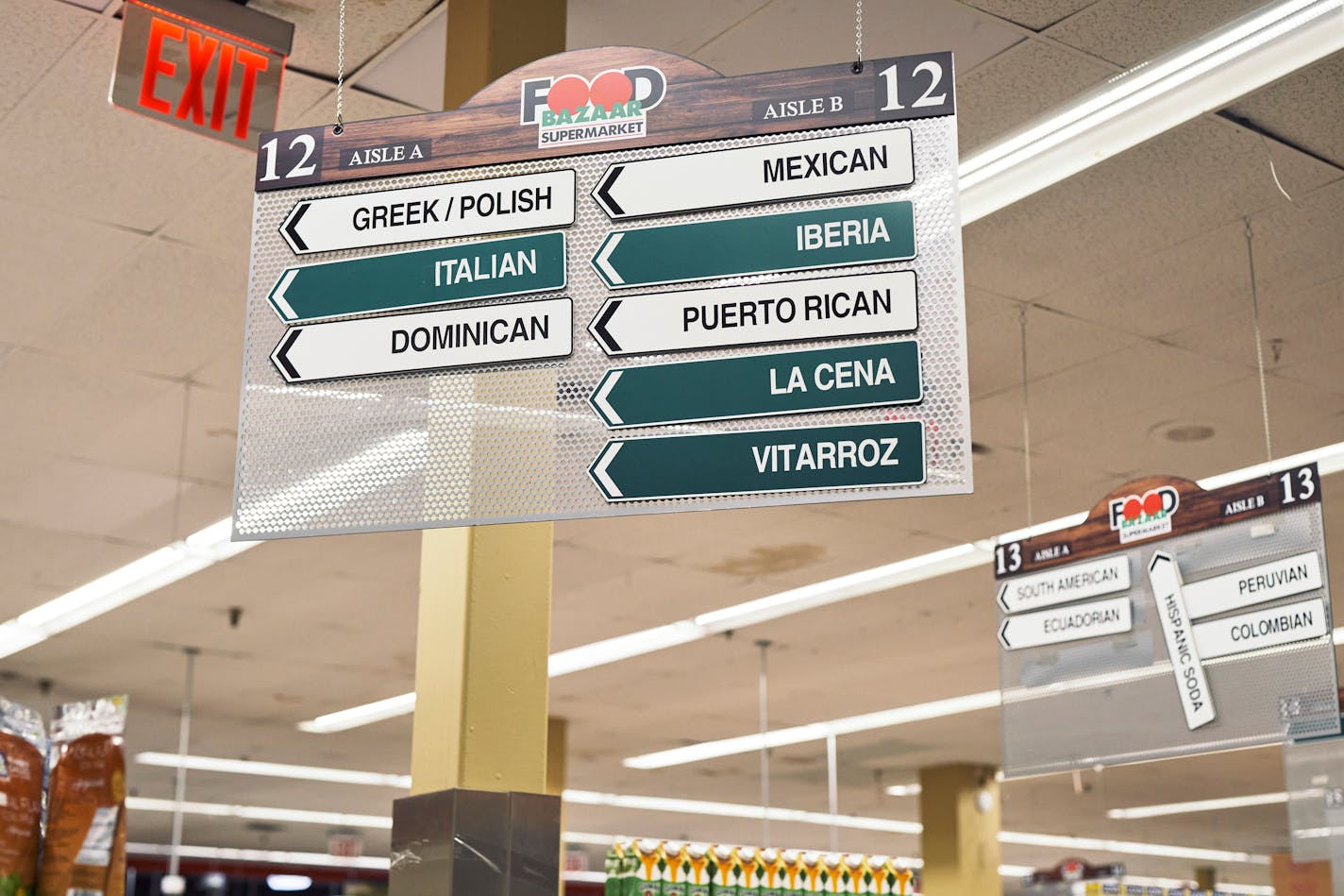 Signage for various collections of products at a Food Bazaar in Queens on July 25, 2021. This international hodgepodge strikes many shoppers and food purveyors as antiquated but doing away with it isn't as easy as it might sound. (An Rong Xu/The New York Times)