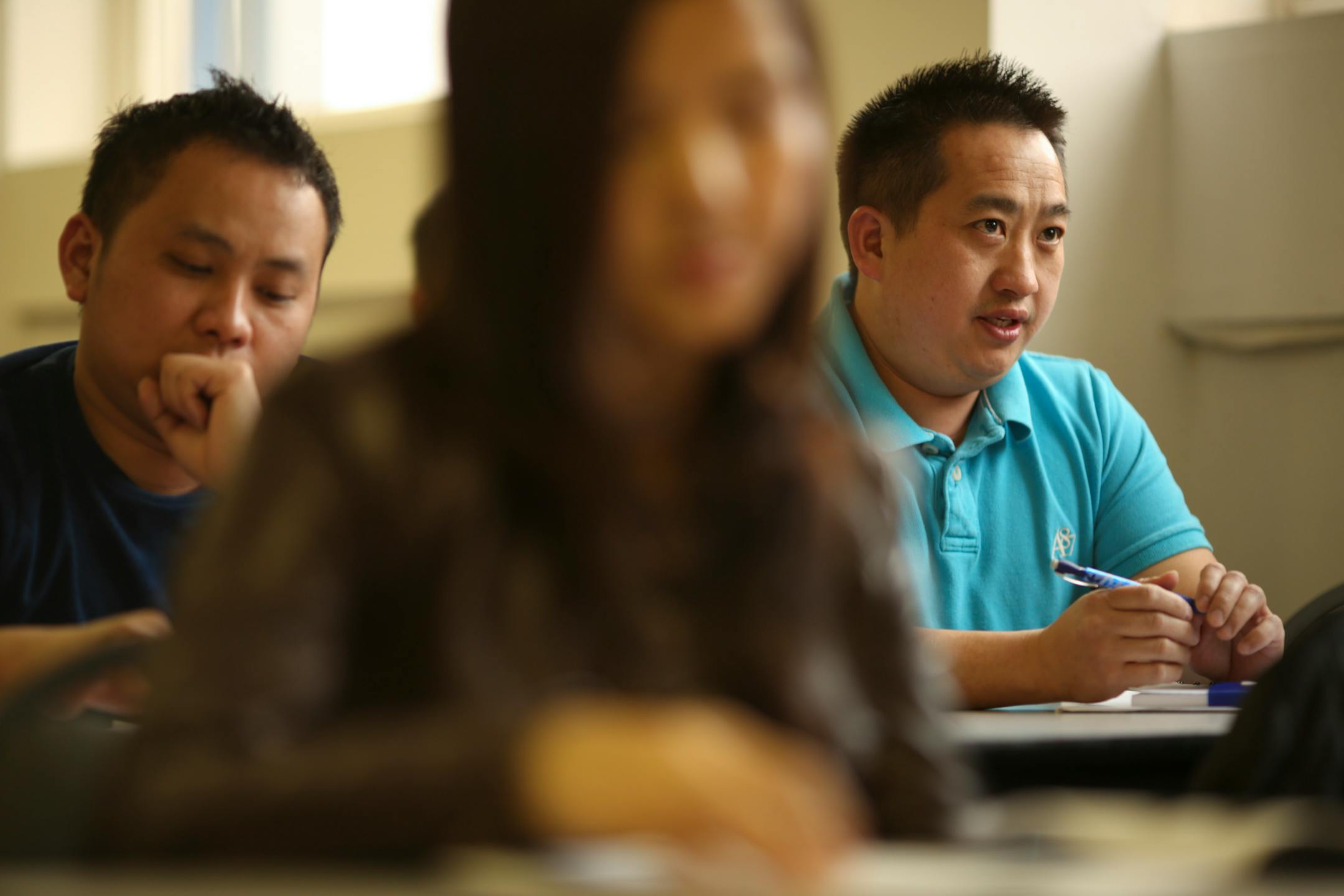 Xiong Thao, right, answereda question about the U.S. government during the U.S. citizenship class at the Hmong Cultural Center of Minnesota Wednesday afternoon. At left was Bee Moua.