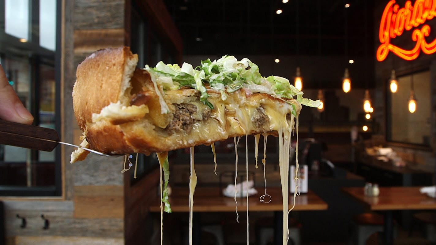 The Juicy Lucy Pizza at Giordano&#x2019;s. A deep-dish crust stuffed with seasoned ground hamburger, American and mozzarella cheeses, caramelized onions and topped with salad. Thursday, October 11, 2018 in Minneapolis, Minnesota. ] Matt Gillmer / Star Tribune 101818