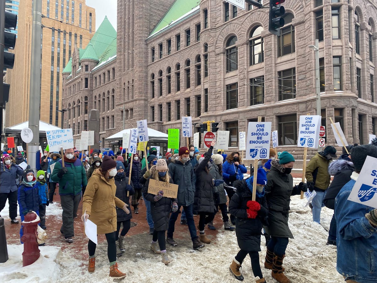 Hundreds of educators and families marched through downtown Minneapolis on Monday in support of higher wages for educational support professionals wor