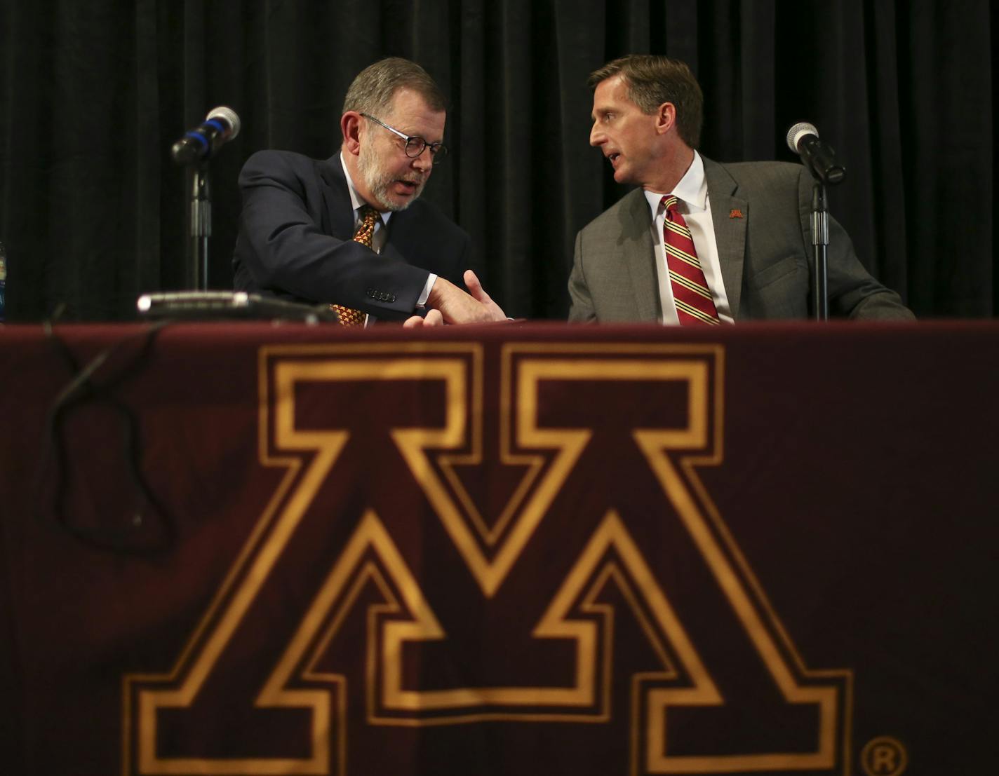 Mark Coyle shook hands with U of M President Eric Kayler, at the conclusion of the news conference where he was introduced as Minnesota's new athletic director Wednesday at TCF Bank Stadium.