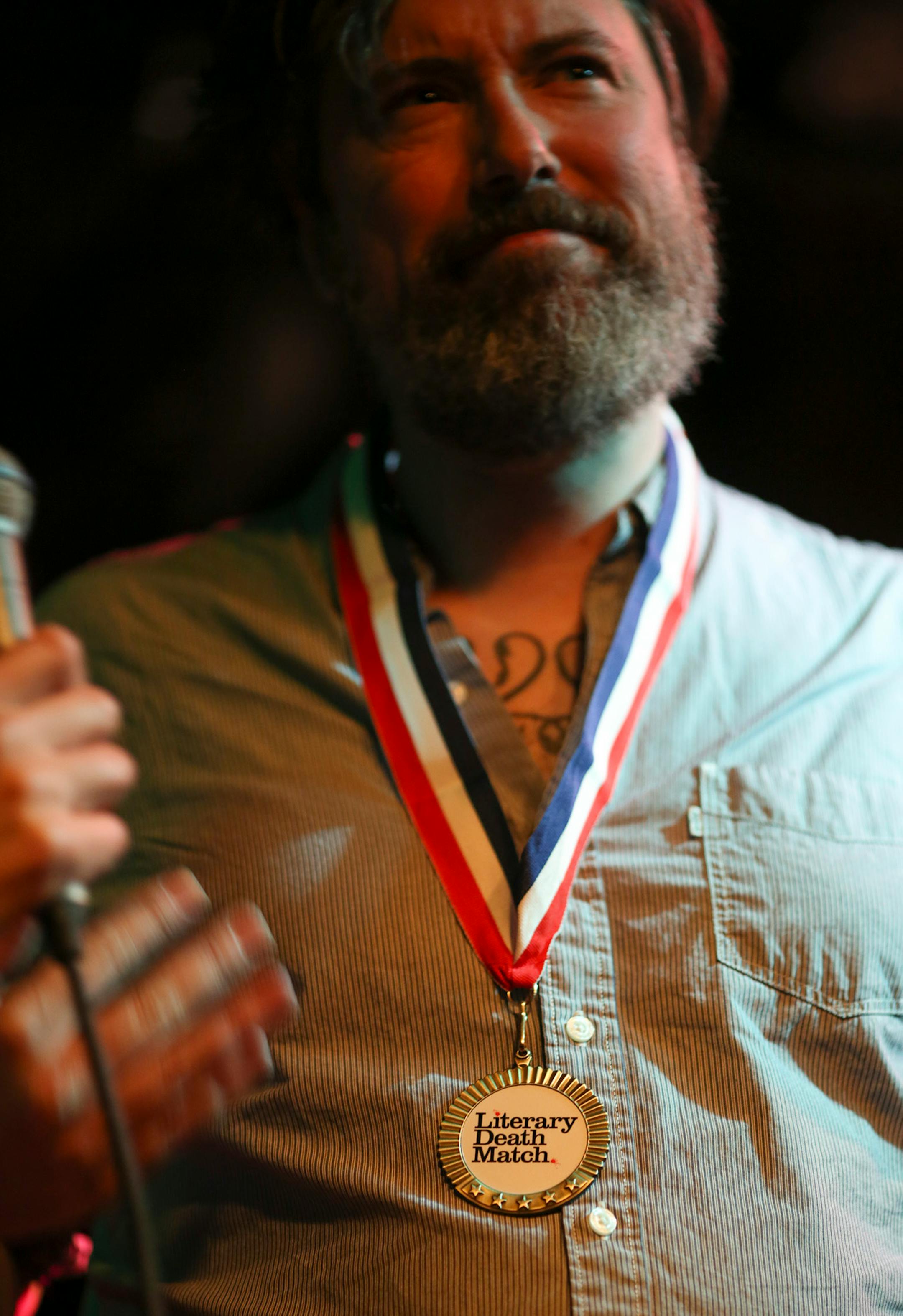 Author Mark Doten won the Literary Death Match championship medal Wednesday night at Nomad World Pub. ] JEFF WHEELER ï jeff.wheeler@startribune.com One of the off-site events at the start of the AWP Conference & Bookfair was the Literary Death Match Wednesday night, April 8, 2015 at Nomad World Pub in Minneapolis. Four writers read their work and were judged by a panel of three all star judges.