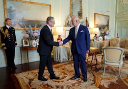 Britain's King Charles III, right, shakes hands with Keir Starmer where he invited the Labour Party leader to become prime minister and to form a new 