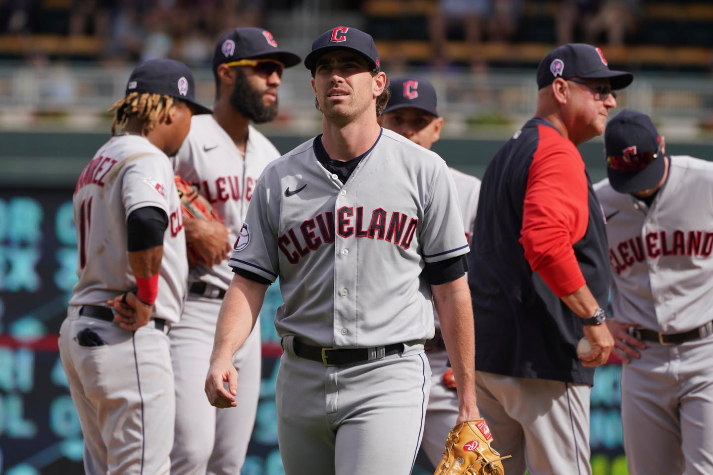 Cleveland Guardians starting pitcher Shane Bieber, center, heads to the dugout after he was pulled in the seventh inning of a baseball game against the Minnesota Twins, Sunday, Sept 11, 2022, in Minneapolis. (AP Photo/Jim Mone)