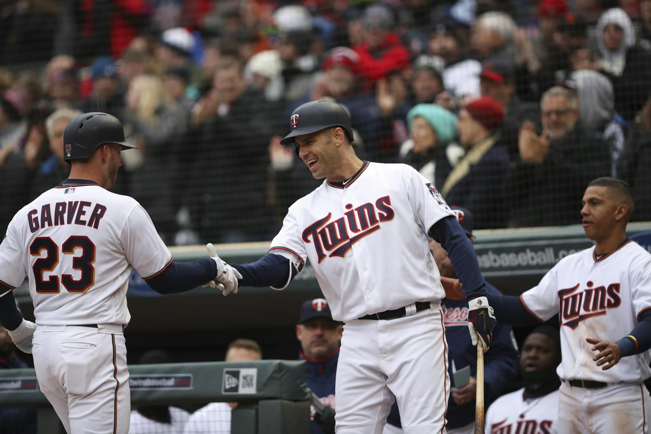 Minnesota Twins catcher Mitch Garver (23) was congratulated by Minnesota Twins first baseman Joe Mauer (7) after his seventh inning home run put the Twins ahead of Seattle 3-2.